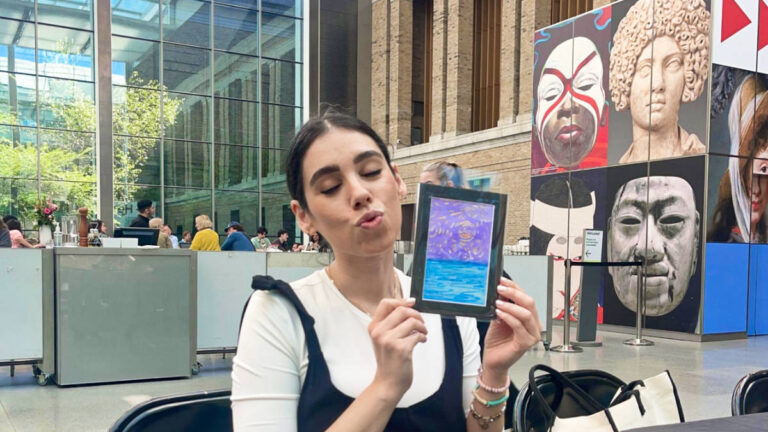 The author Claudicet Pena, holding her artwork at the Museum of Fine Arts in Boston