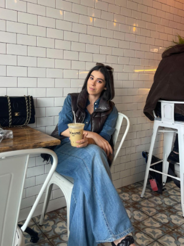 The author Claudicet Pena, sitting inside the Localito Cafe with her matcha latte