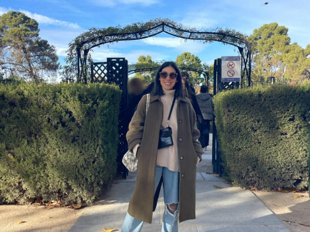 The author Claudicet Pena, posing for a photo at the entrance of La Rosaleda