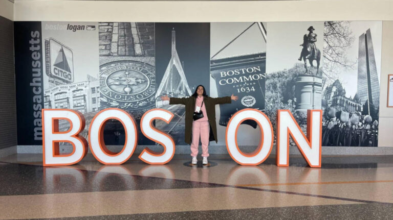 The author Claudicet Pena, standing on the letter T of the BOSTON landmark signage