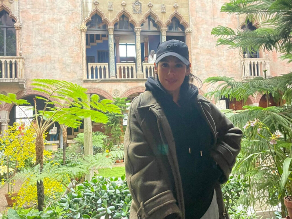 The author Claudicet Pena, posing for a photo at the Venetian-style courtyard of Isabella Stewart Gardner Museum