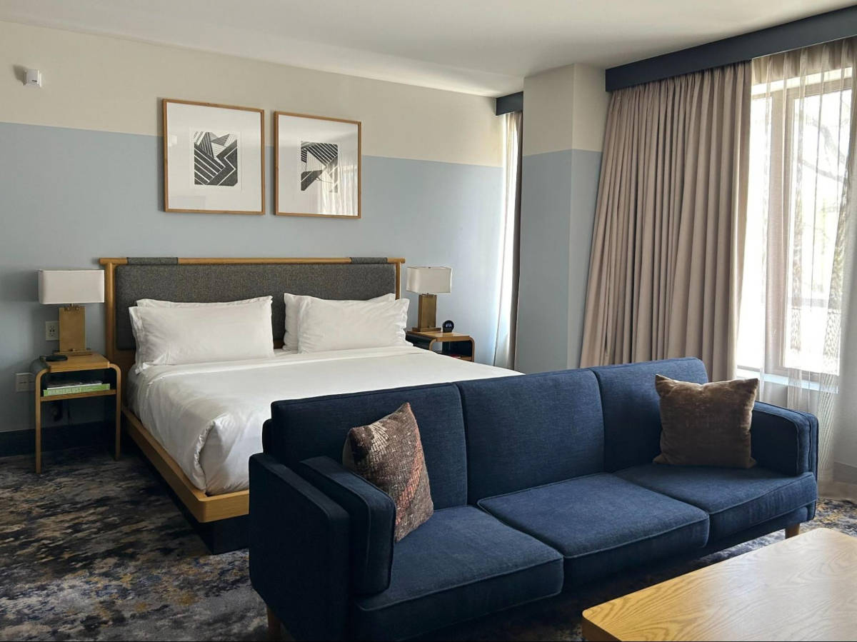 The huge bed and the seating area inside the room in Clayton Hotel