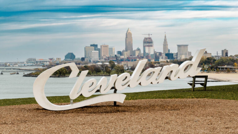 The iconic Cleveland script sign with the cityscape in the background
