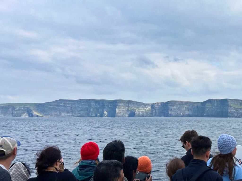 People admiring the Cliffs of Moher from the boat tour