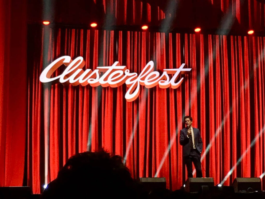 John Mulaney on the stage performing at Clusterfest