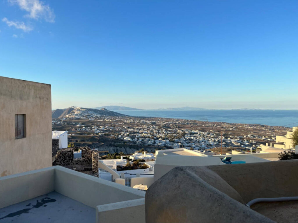 Overlooking view of the both sides of Santorini from the Pyrgos