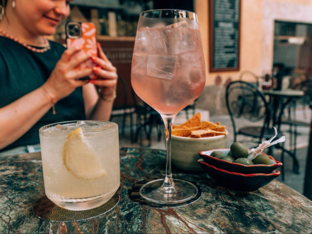 Glasses of cocktails with olives and chips on the side