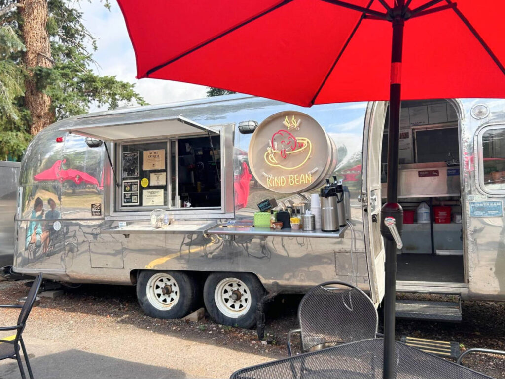 View of the tables and chairs in front of a coffee truck