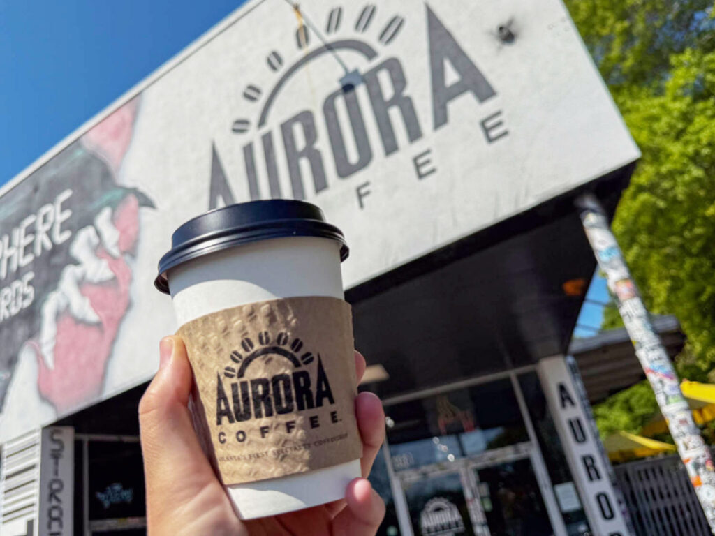 Holding a cup of coffee from Aurora