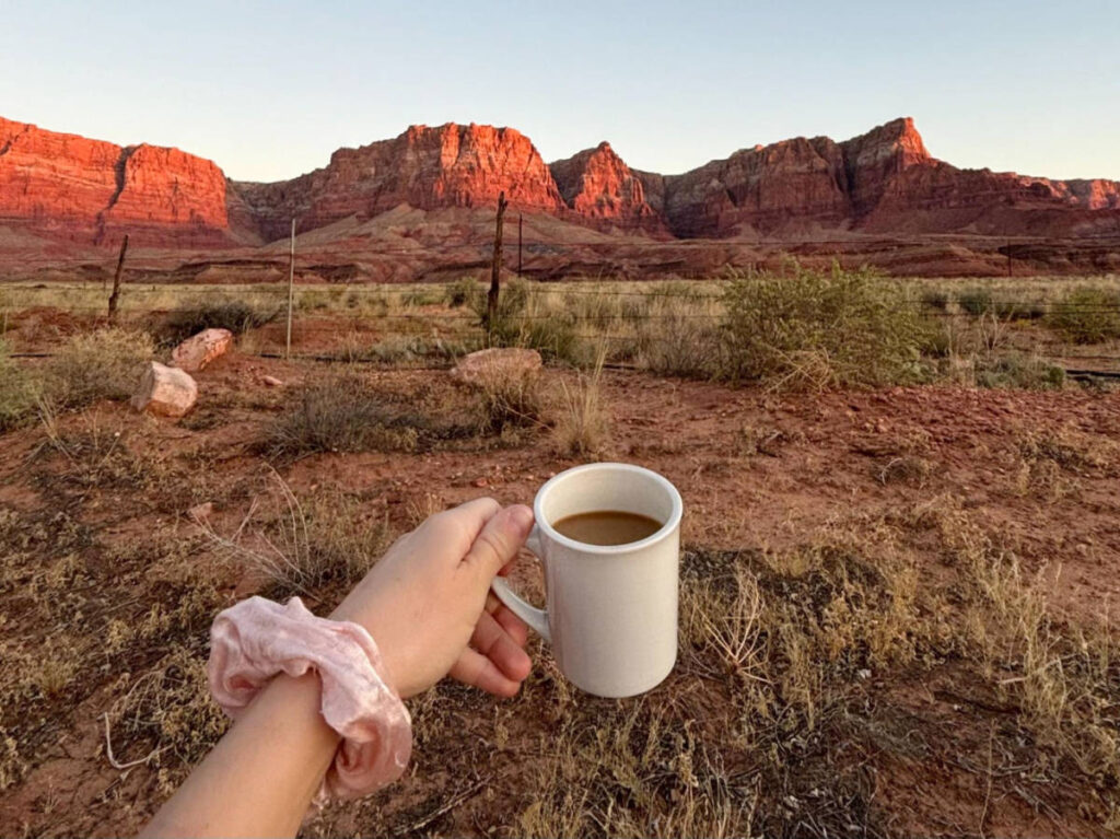 A mug of coffee with a scenic view on the background