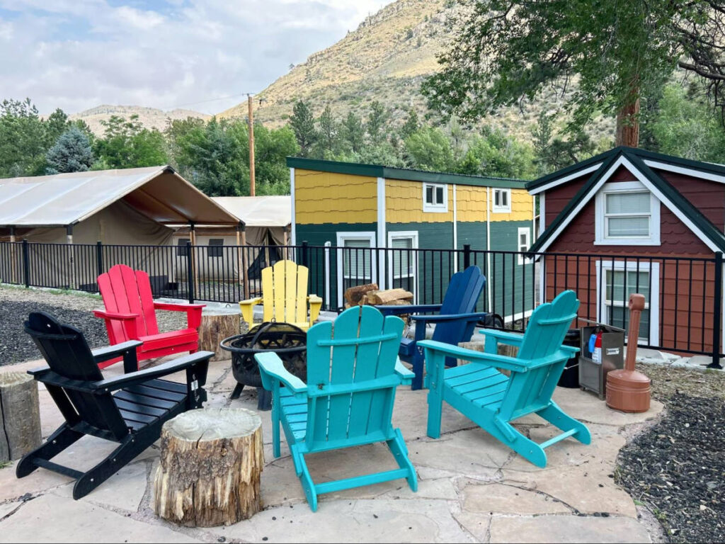 View of the colorful chairs around a fire ring at the Riverside Colorado