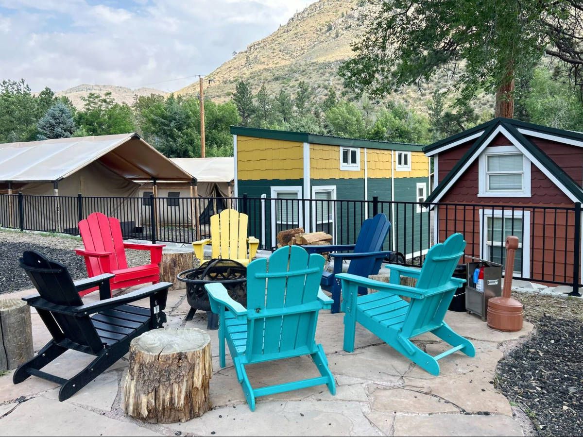 View of the colorful chairs around a fire ring at the Riverside Colorado