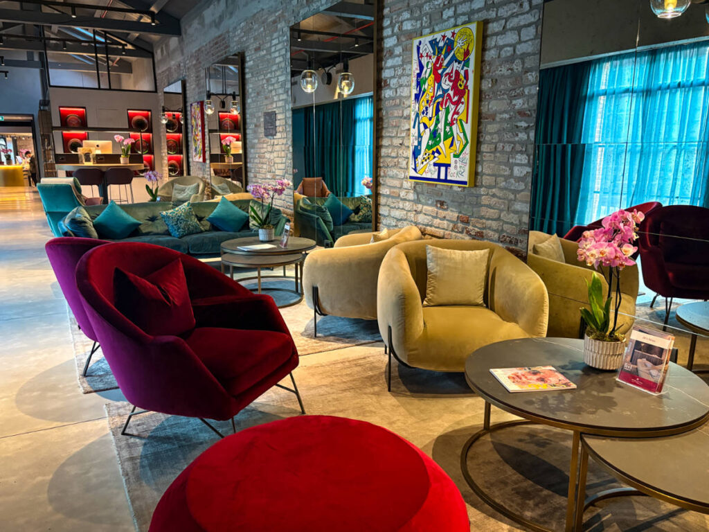 View of the colorful seats at the common space of NH Collection Murano Villa