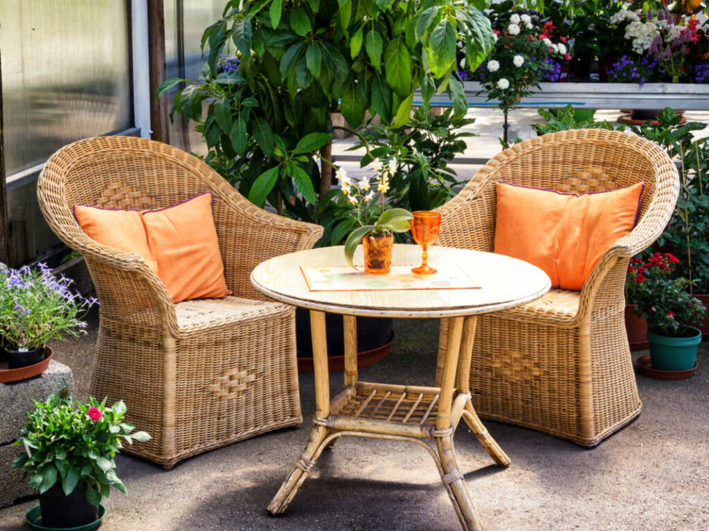 A cozy patio surrounded by blooming flowers