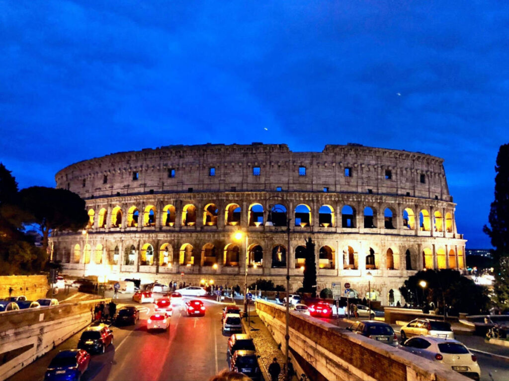 Panoramic view of the shell of the Colosseum at night