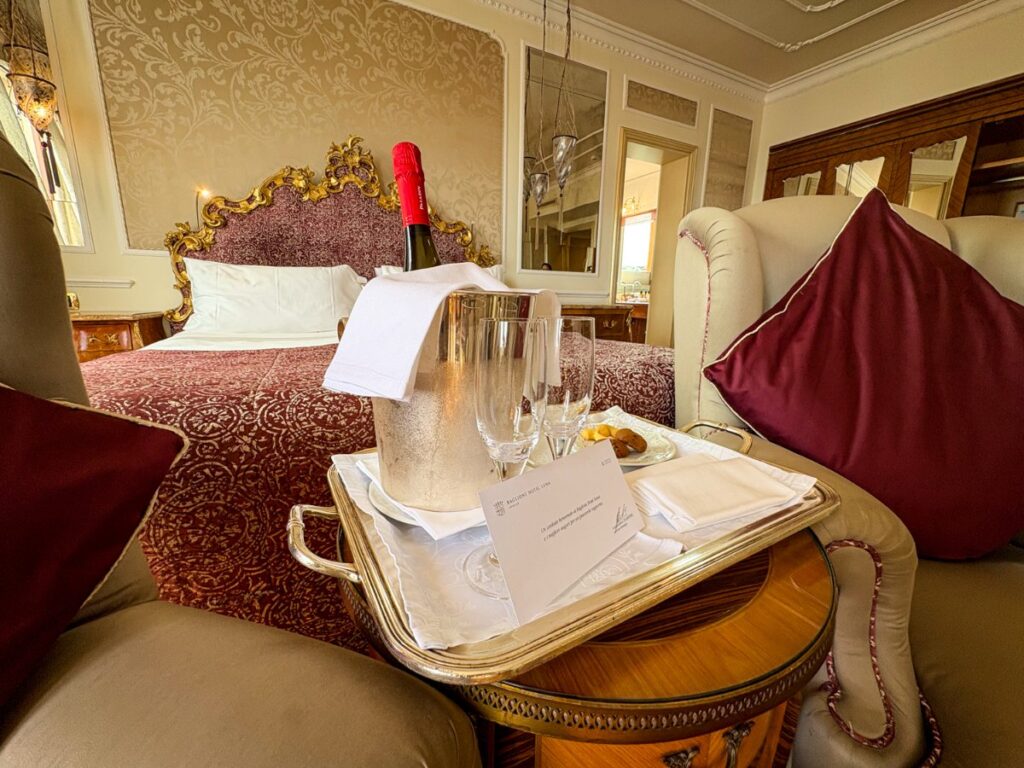 A Complimentary bottle of prosecco near the bed