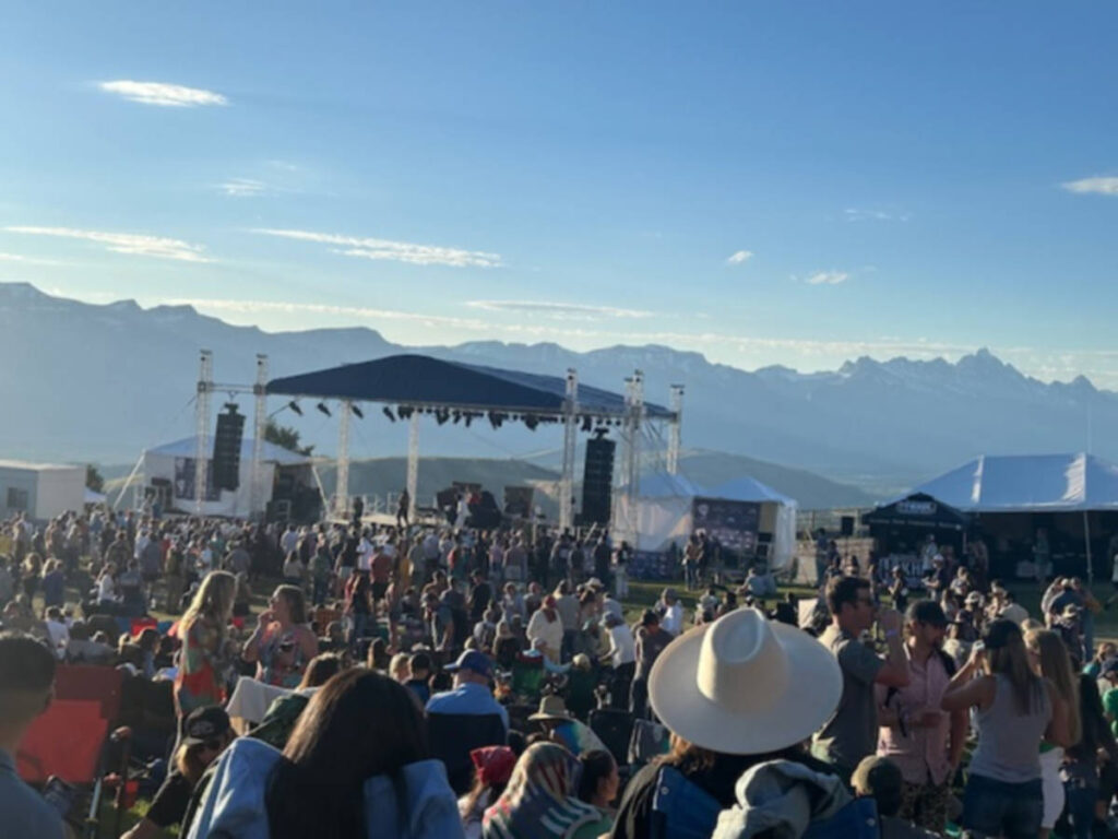 The crowd watching an outdoor concert in an open stage