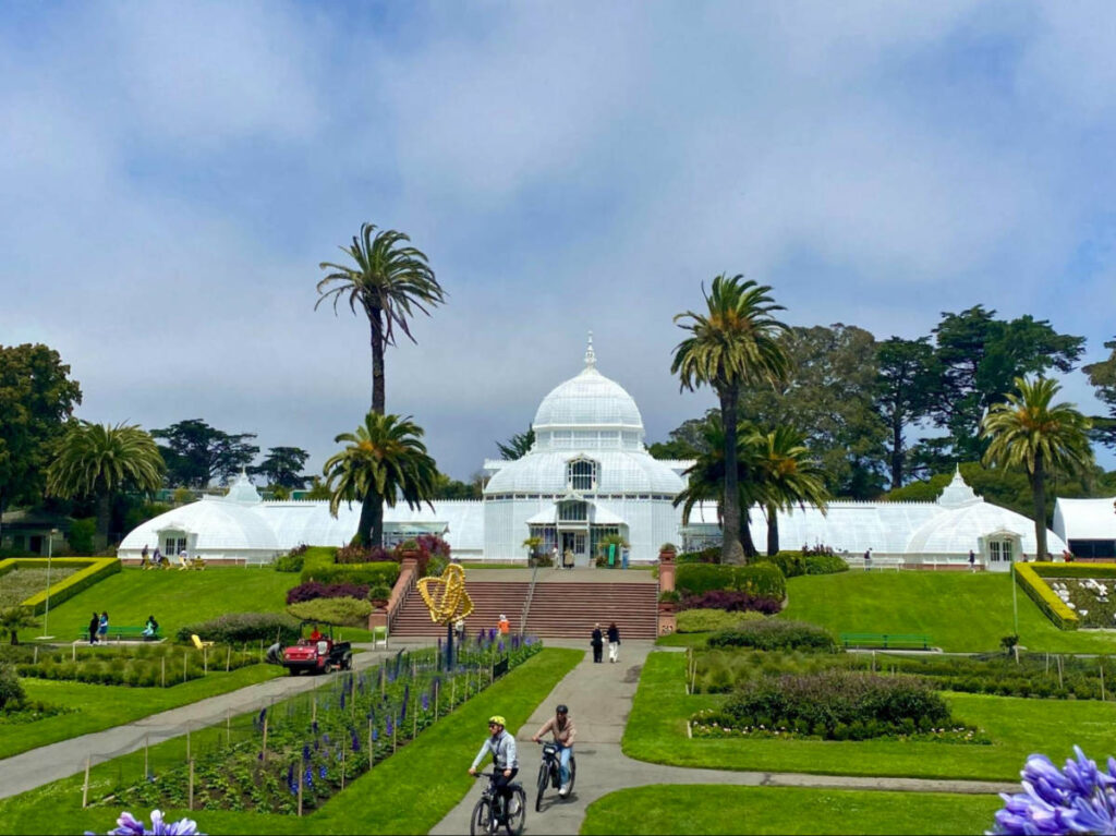 People riding a bike at the Conservatory of Flowers