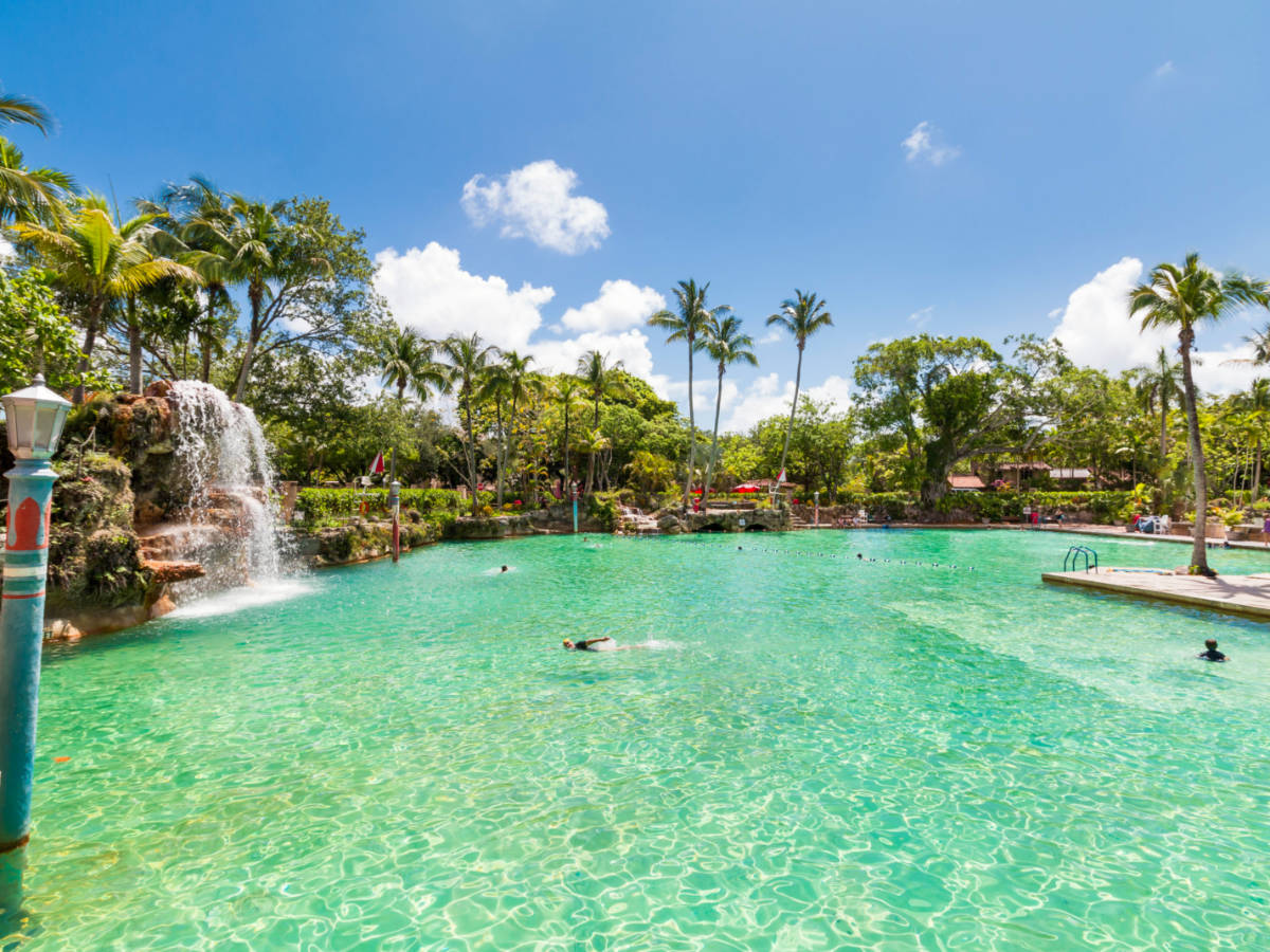 People swimming at the Venetian Pool at Coral Gables