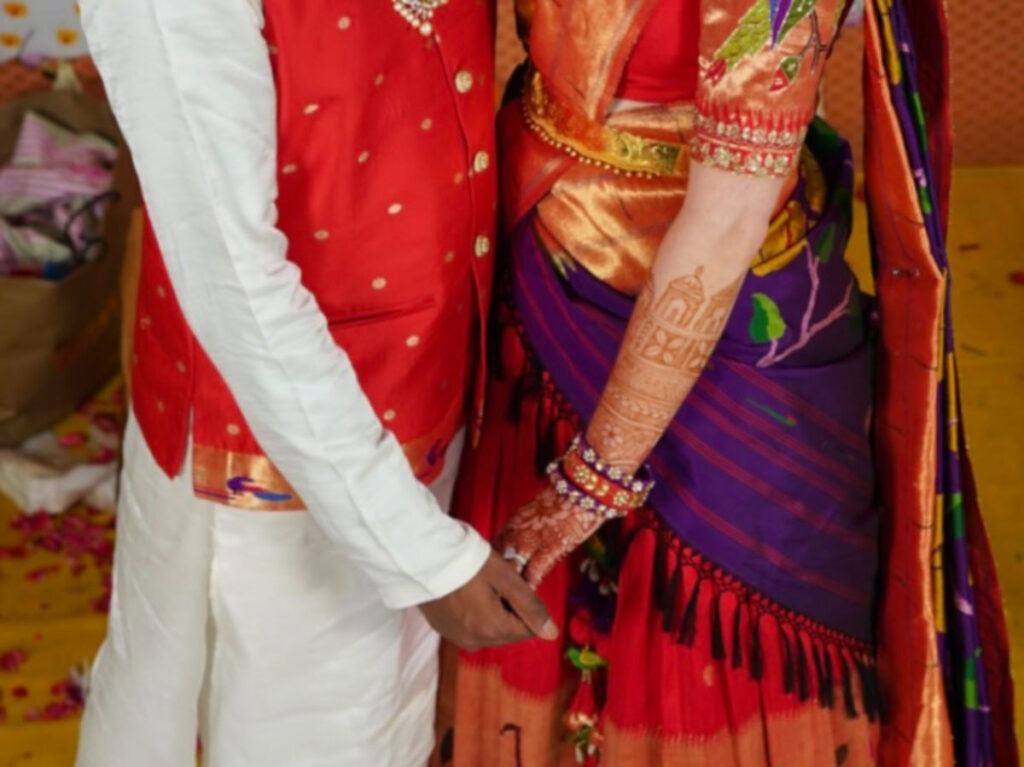 View of the vibrant details of the couple’s outfits for the Indian wedding