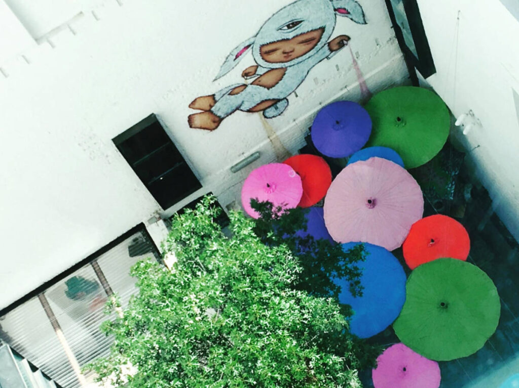 Overlooking view of the colorful umbrellas and mural at the courtyard in Long Chim