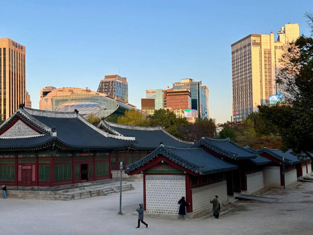 View of the main courtyard of Deoksugung Palace with City Hall and office buildings around