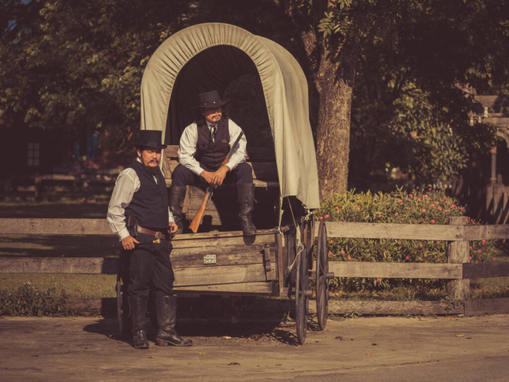 Two cowboys on the carriage wearing western style