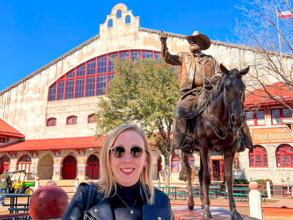 Author Sarah Heath in front of the Cowtown Coliseum in the Fort Worth Stockyards