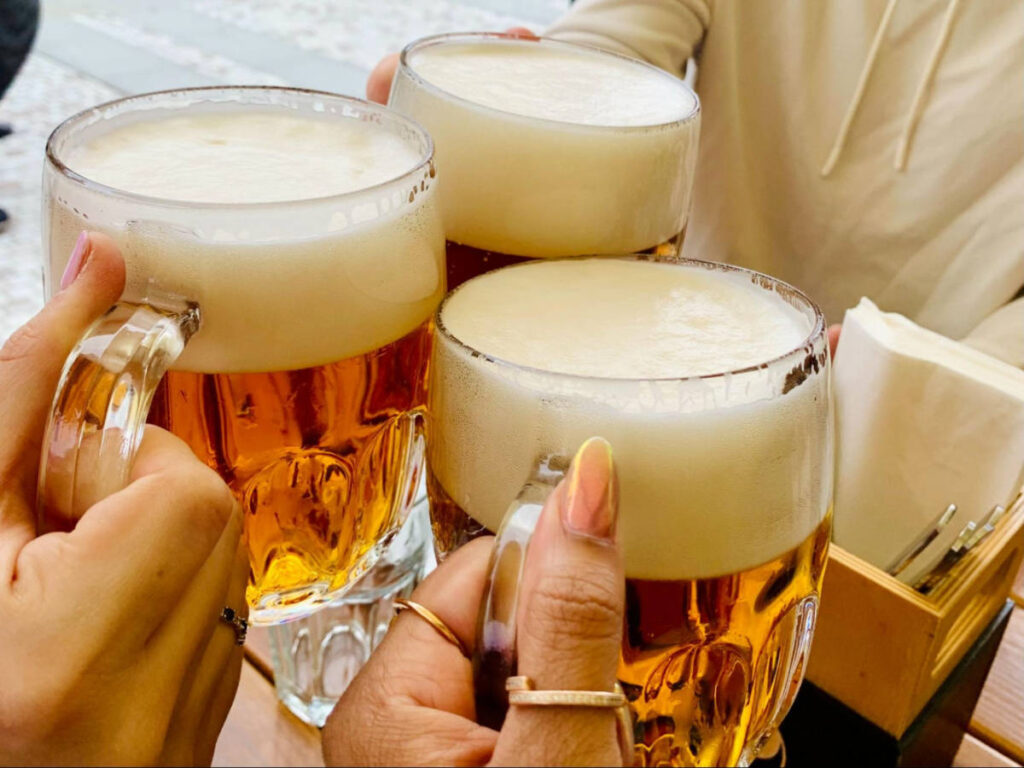 People tossing their glasses of Craft beers at Dva Kohouti