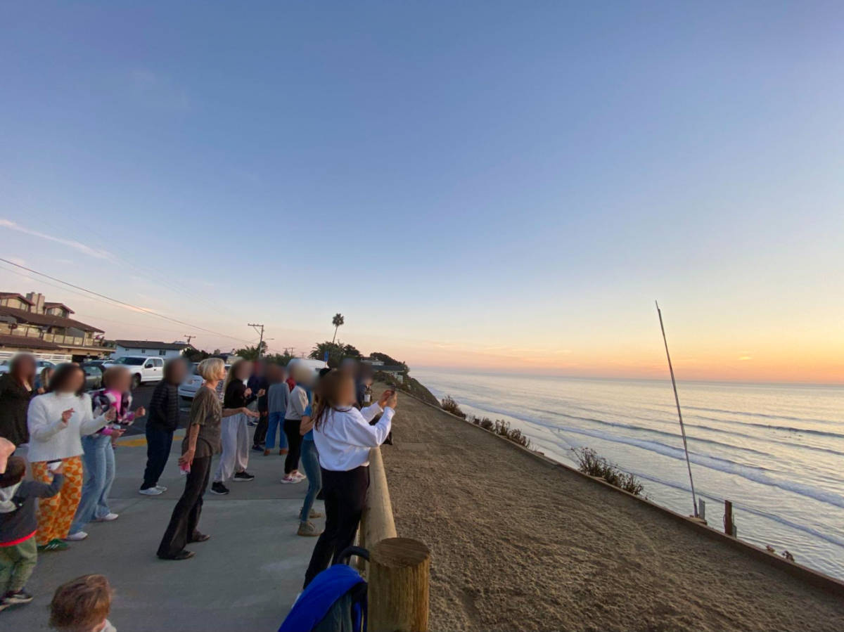People enjoying the sunset views near the Beacon’s Beach