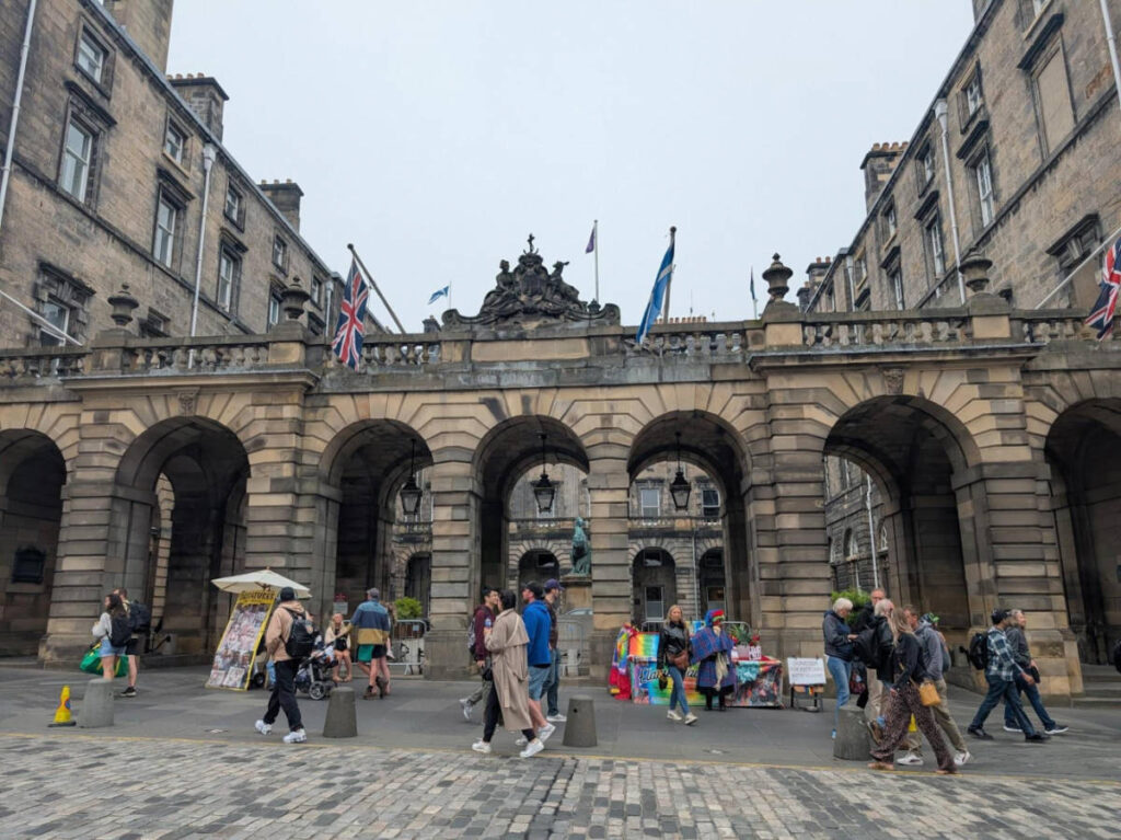 People walking along the City Chambers in Edinburgh