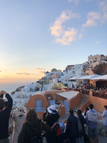 The crowd admiring the scenic views of Santorini at sunset