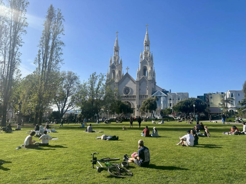 The crowd hanging out and overlooking the Saints Peter and Paul Church at Washington Square Park