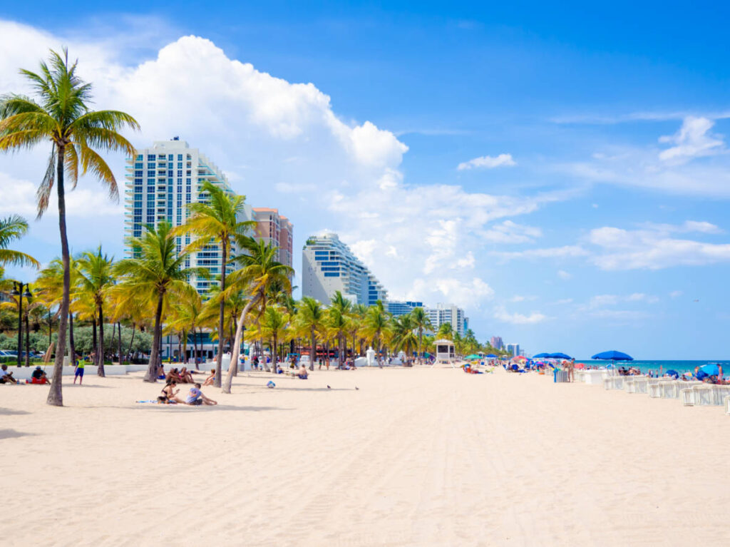 The people enjoying the white sand beach and skyline views at Fort Lauderdale beach