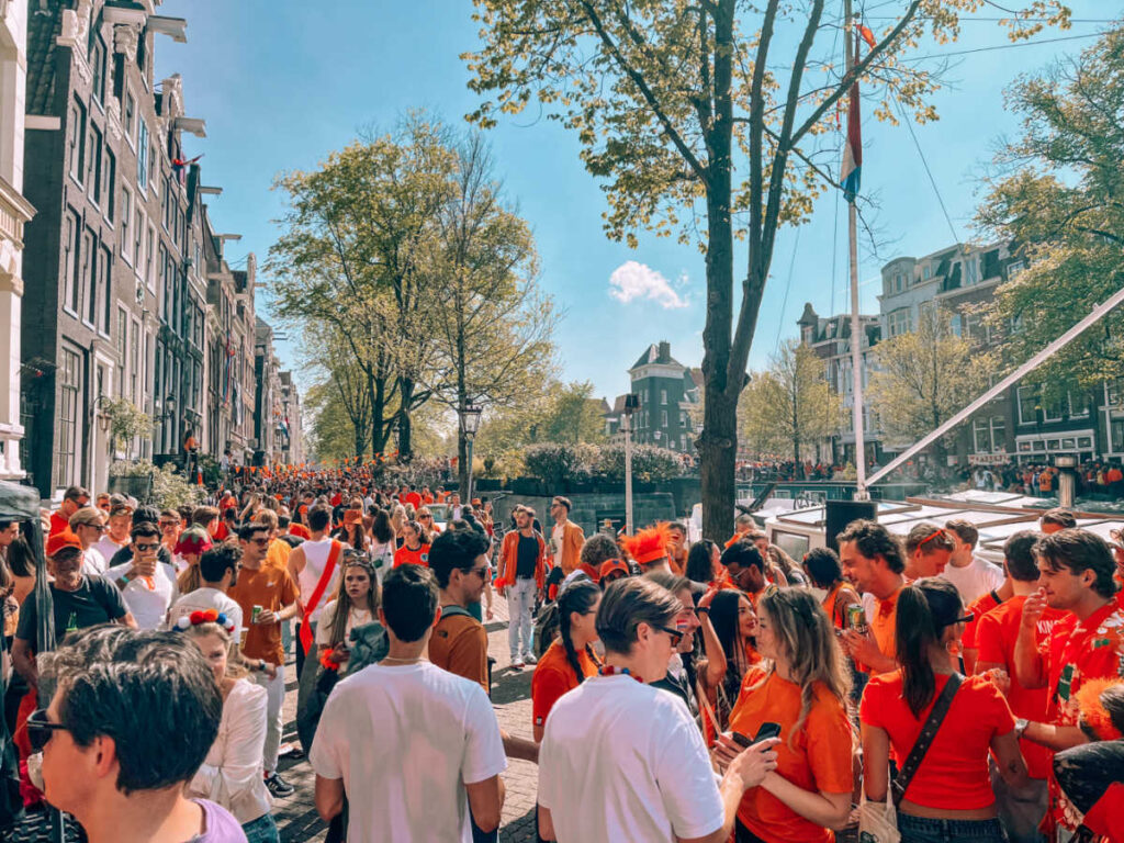View of the crowd wearing orange and white shirts on King’s Day
