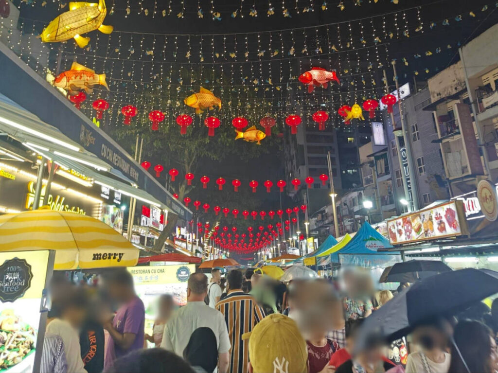The vibrant red lanterns over the crowded Jalan Alor food market