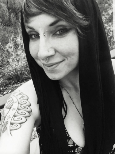 Crystal Reisinger, taking a photo of herself in black & white
