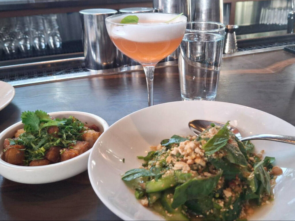 The cucumber salad and pork belly with a glass of cocktail at Lulu Bar