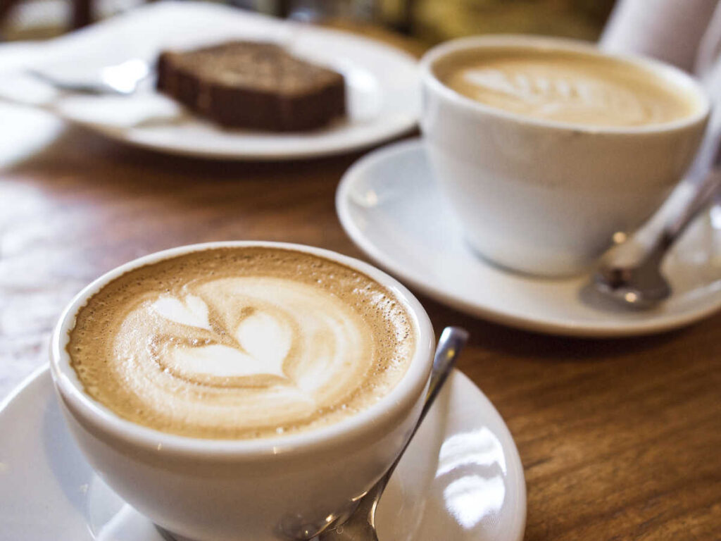 Two cups of coffee on a wooden table