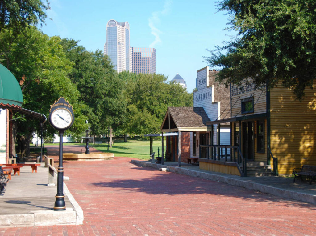 Landscape view of the main street in the Dallas Heritage Village with an ornamental clock on the sidewalk