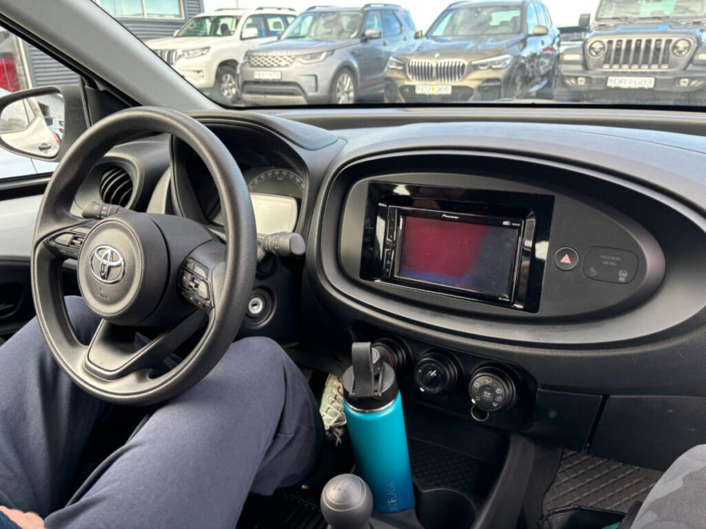 Closeup look of the steering wheel and the dashboard inside the car