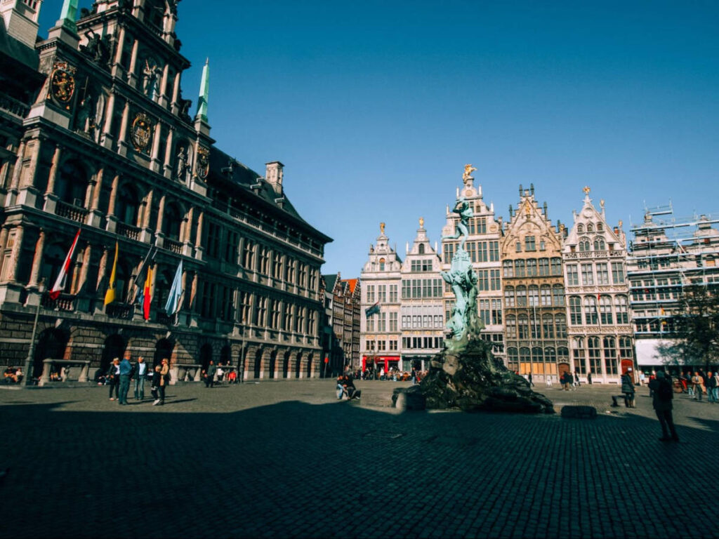 Panoramic view of the intricate architecture and the statue in the center in De Grote Markt