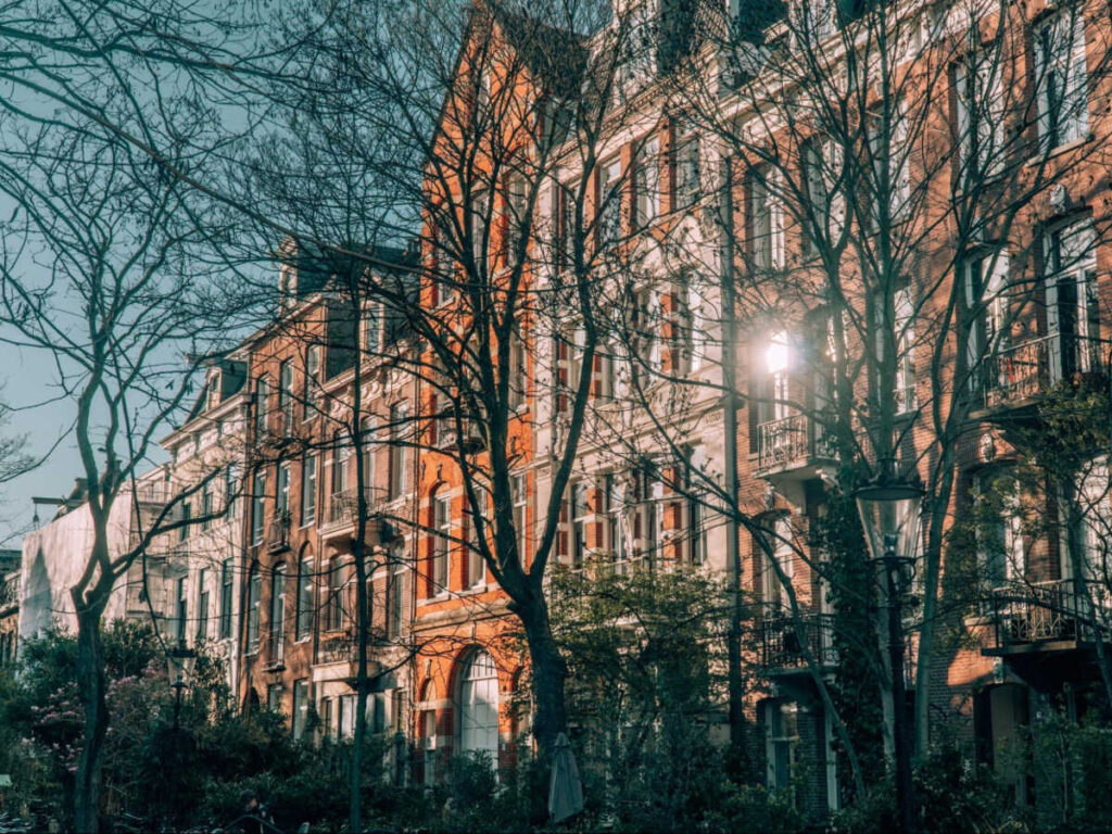 View of the beautiful buildings at the tree filled street of De Plantage