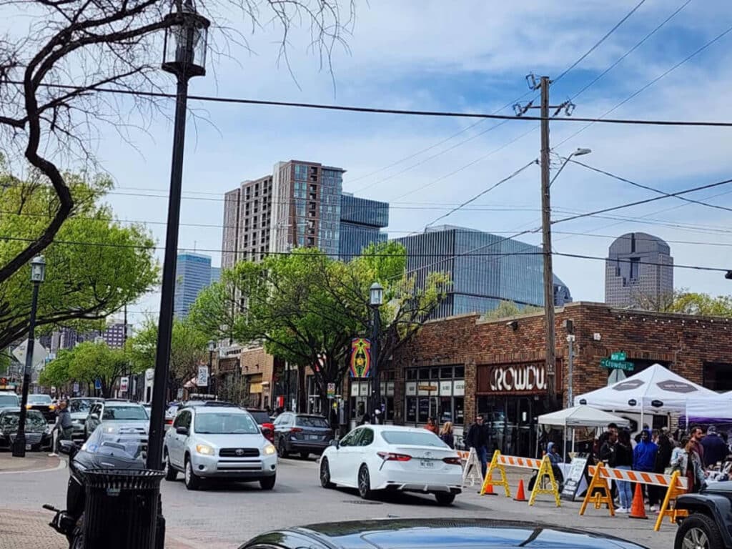 Vehicles and people on a street in Deep Ellum