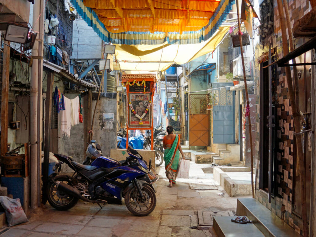A woman walking along the congested interior lanes of Dharavi’s slum settlement