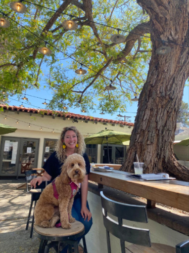 Jess Levy and her dog sitting on a stool at Ojai Rotie