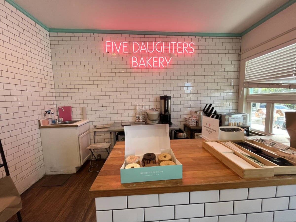 A half a dozen of donuts on the counter inside the Five Daughters Bakery