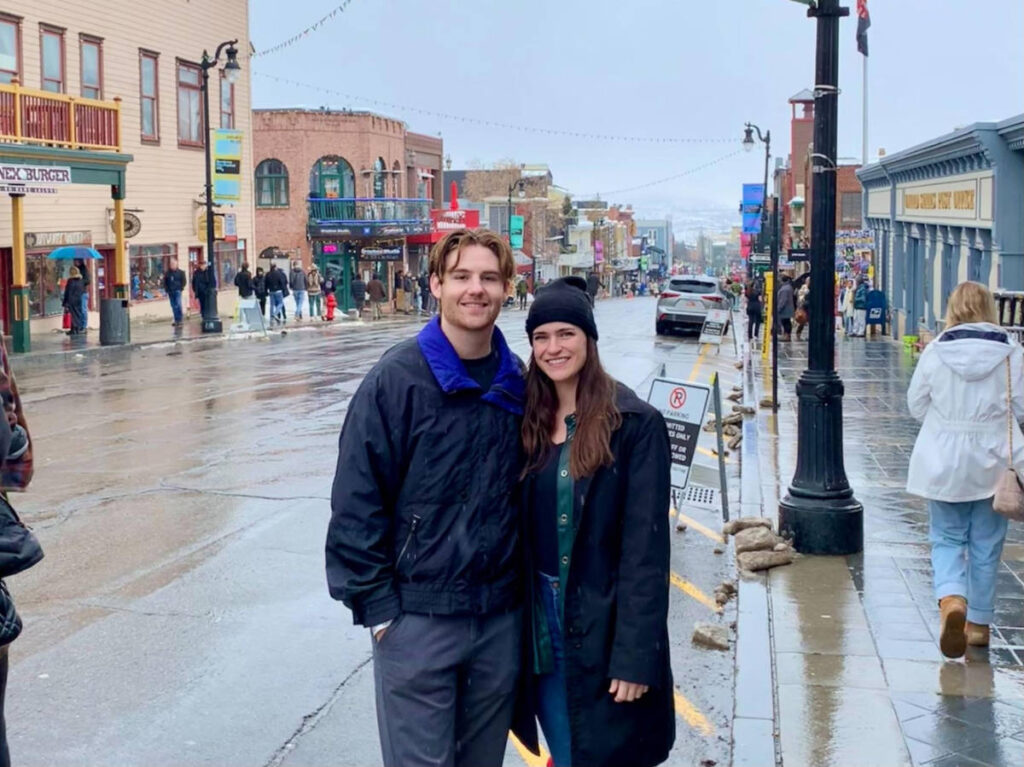 The author Betty Hurd with her boyfriend smiling for a photo in downtown Park City