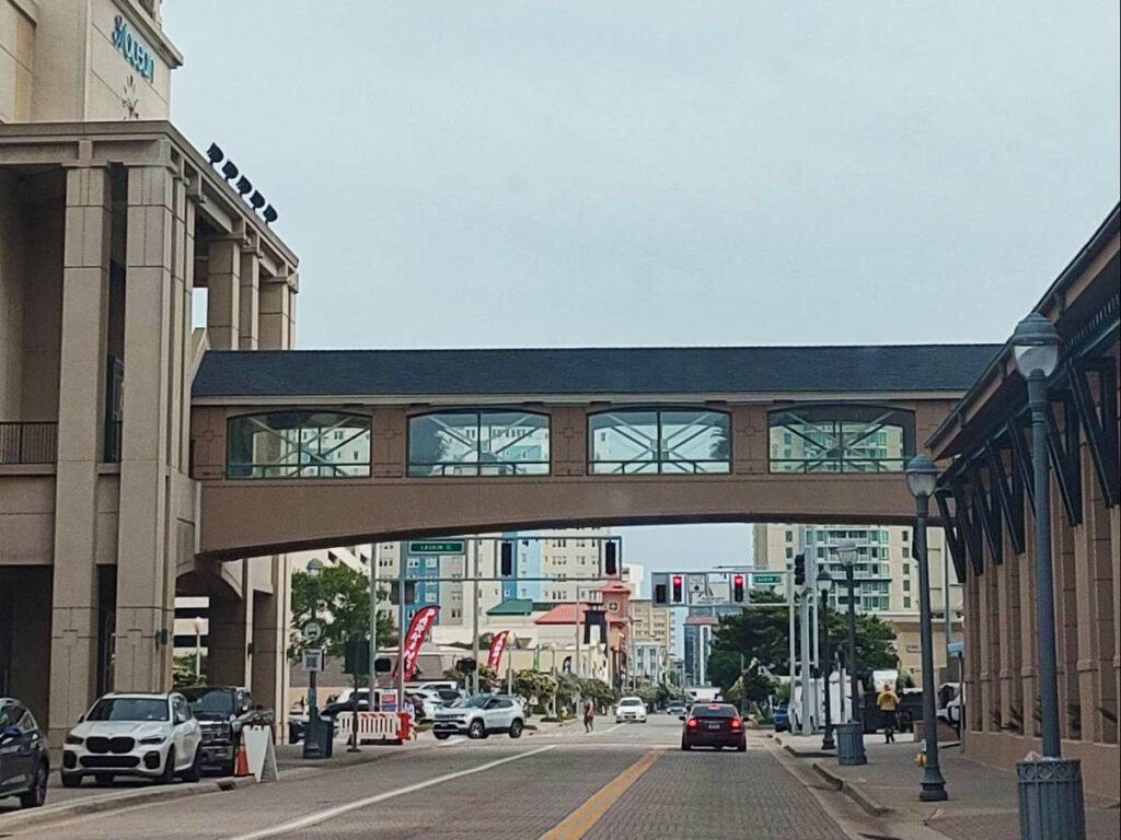 A building in between the buildings and over the street in downtown Virginia Beach