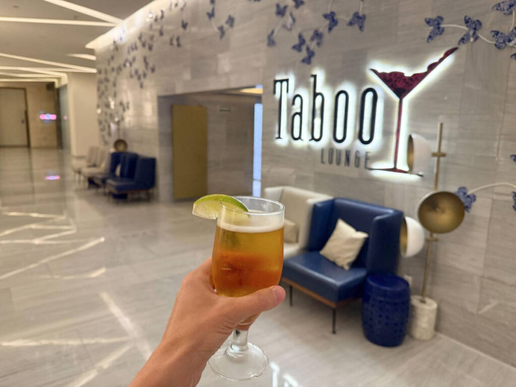 A hand holding a drink in Taboo Lounge